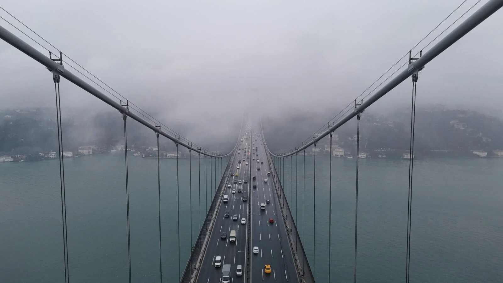 A drone captures the heavy snowfall in istanbul as 15 July Martyrs Bridge partially veiled in dense fog over the Bosphorus