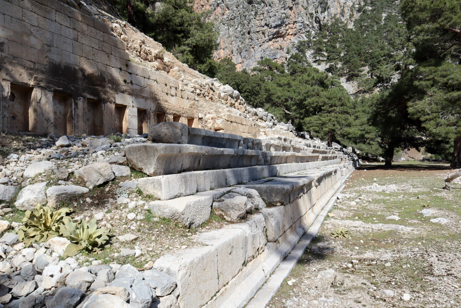 Ruins of Arykanda Stadium in Antalya, Türkiye, nestled in mountainous terrain.