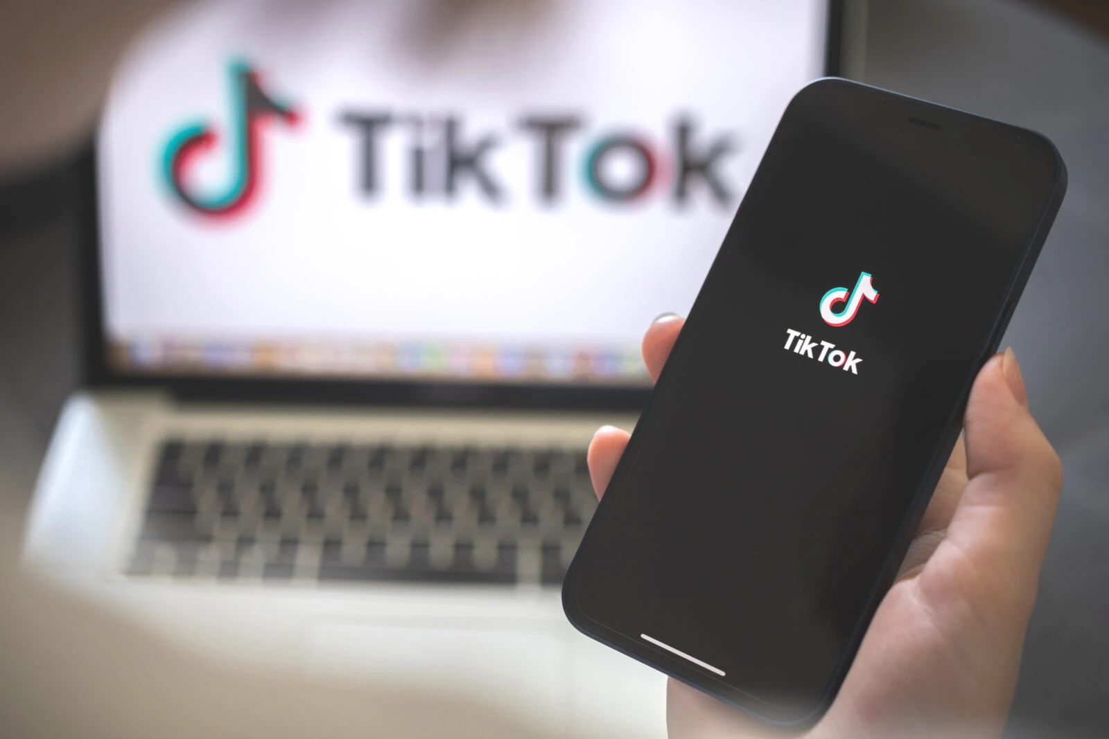 Woman using smartphone with tiktok application