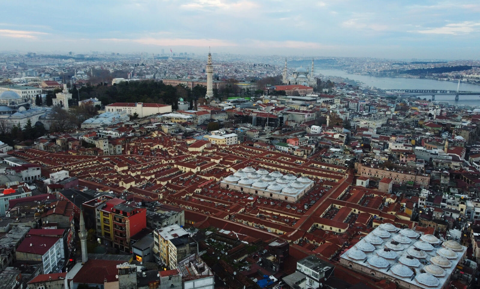 Aerial view of the Grand Bazaar in Istanbul, Türkiye, showcasing its historic covered market structure with a maze of shops and vibrant rooftops.