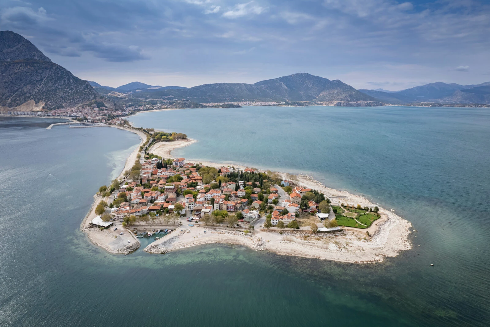 A breathtaking aerial view of Eğirdir Lake in Isparta, Türkiye, showcasing its turquoise waters and surrounding lush landscape.