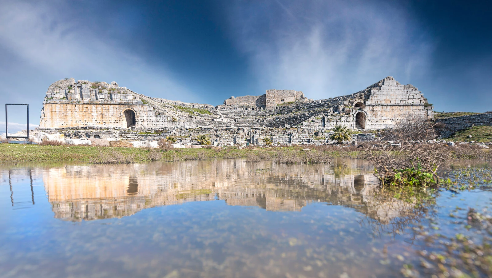 A mesmerizing reflection of the ancient theater of Miletus in rainwater, creating a mirror-like effect in Söke, Aydın, Türkiye.