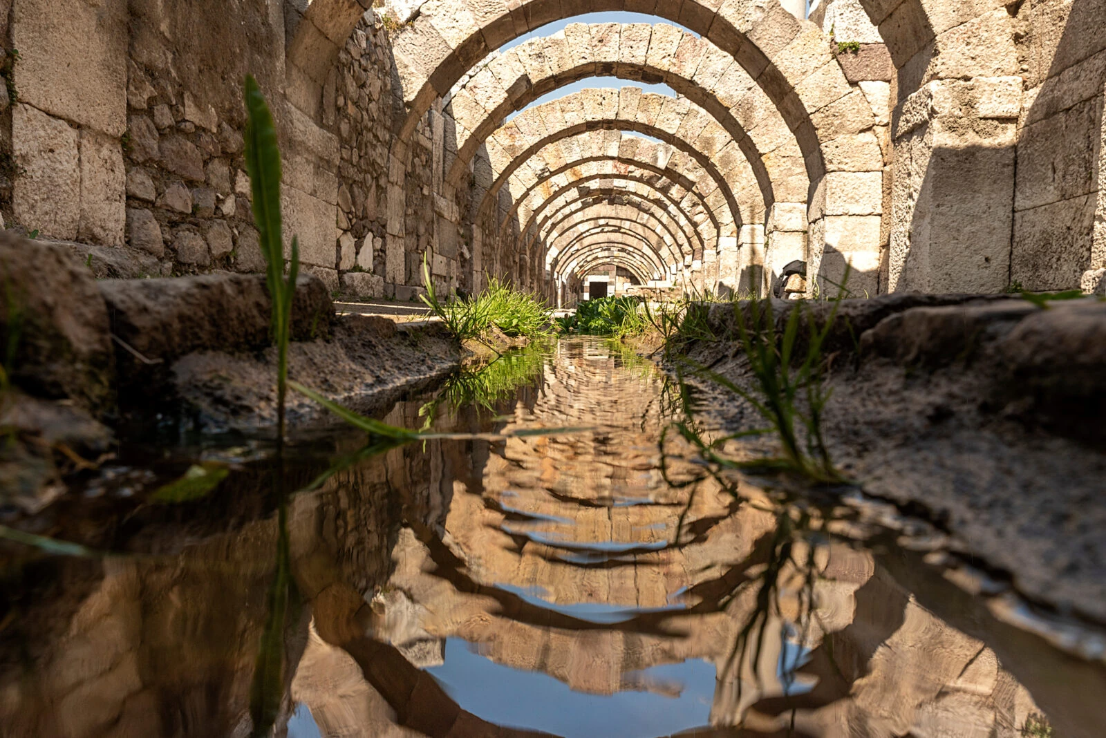 A view of the ancient Smyrna Agora, showcasing its well-preserved stone arches and historical ruins in Izmir, Türkiye.