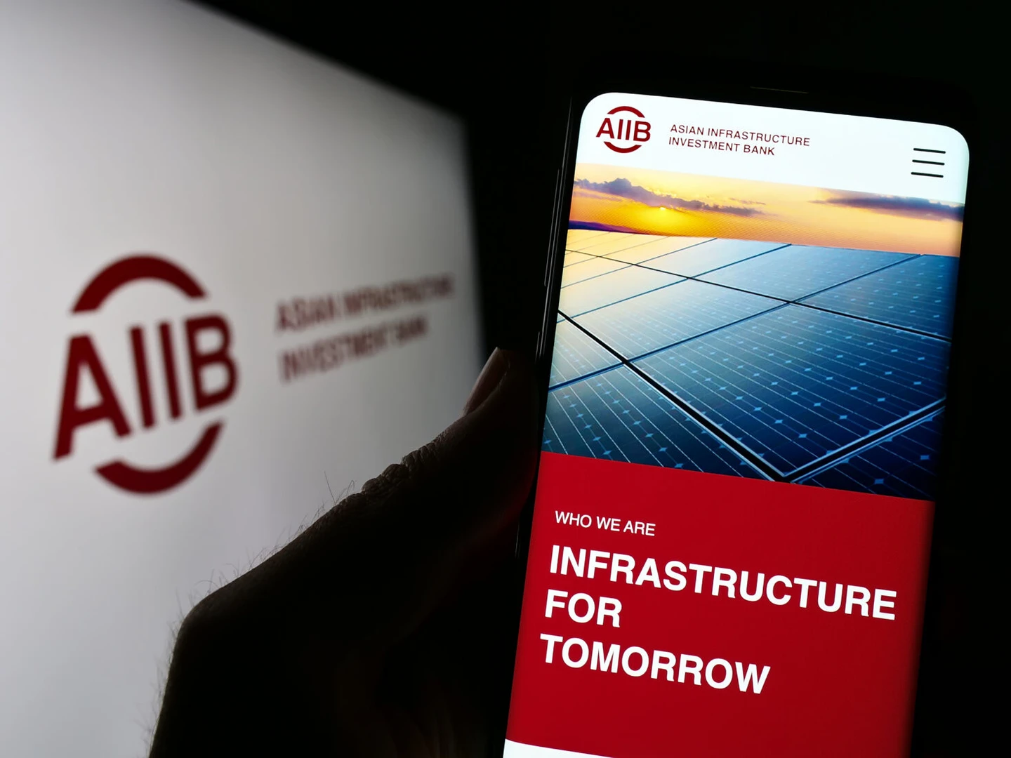 A smartphone screen displaying the Asian Infrastructure Investment Bank (AIIB) website