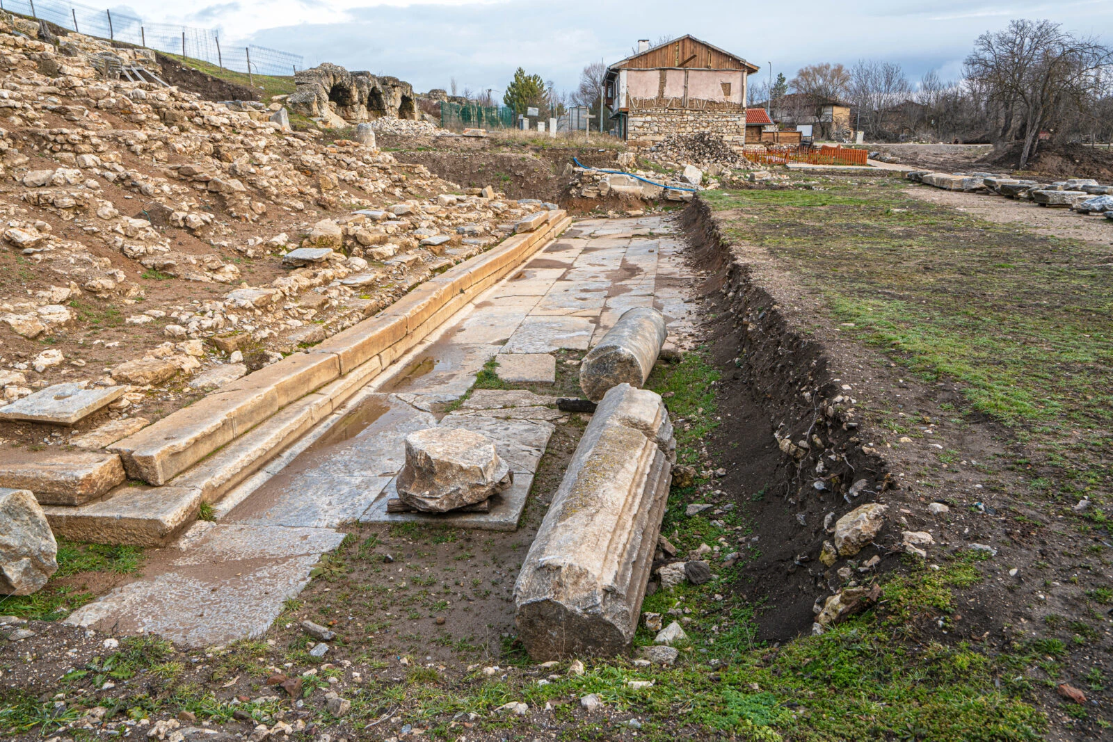 Ruins of Aizanoi Stadium in Kutahya, Türkiye, nestled in mountainous terrain.