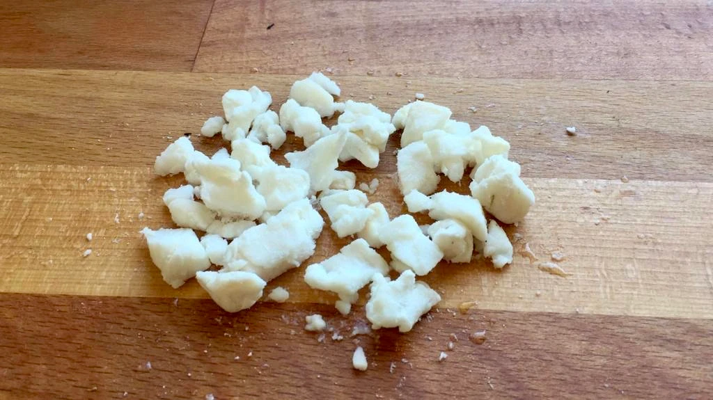 Small pieces of tail fat on a wooden board, used for doner kebab.