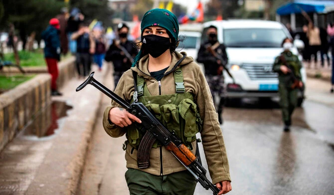 A terrorist member of the PKK/YPG walks