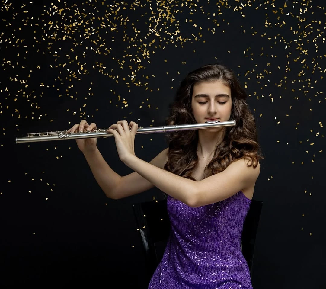 Duru Bulam posing with her flute next to the audience seats, and another image of her playing the flute.