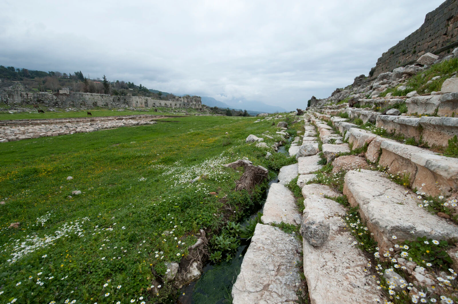 Tlos Stadium in Mugla, Türkiye, set against a dramatic hillside landscape.