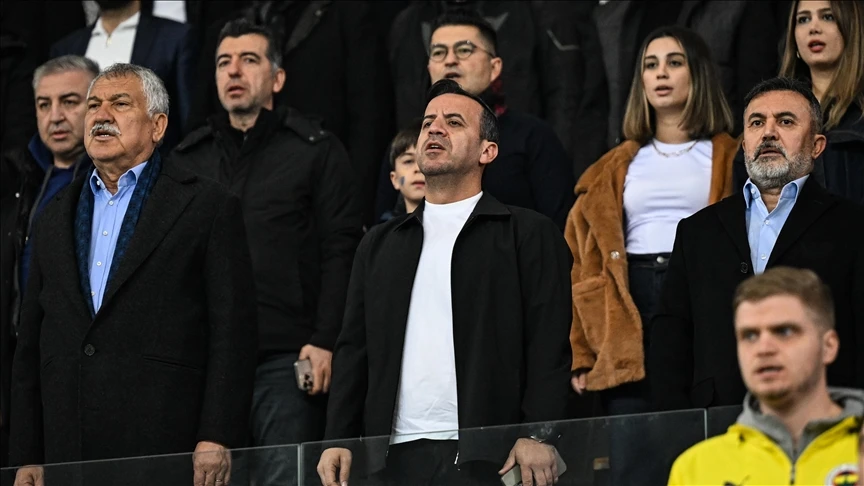 Bedirhan Durak, Adana Demirspor president, and club officials standing solemnly in the stands during the national anthem