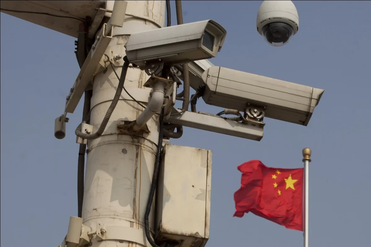 Photo shows surveillance cameras in front of a Chinese flag