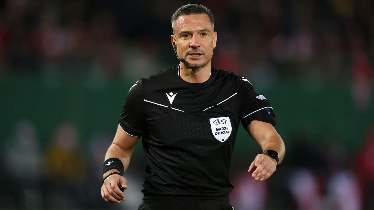 Slavko Vincic in action during a match, who has been a UEFA-listed referee since 2010.