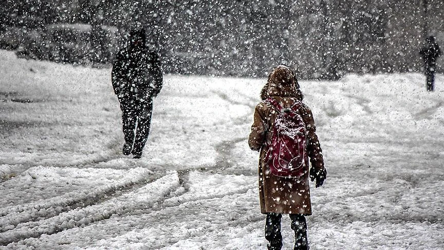 Photo shows a child walking in the snow carrying a school bag in Turkey.