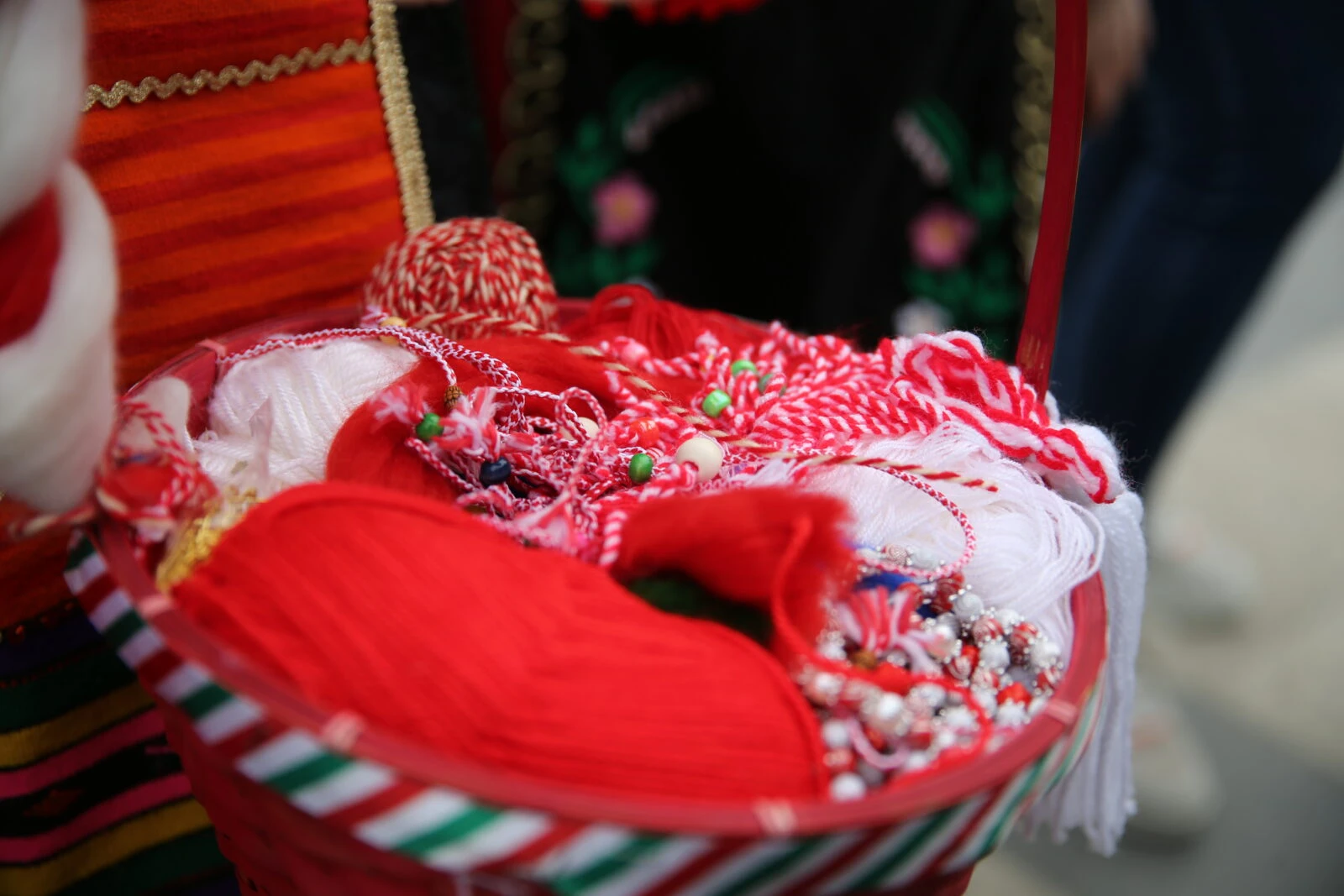 A basket filled with colorful martenitsa bracelets in Edirne, Türkiye.