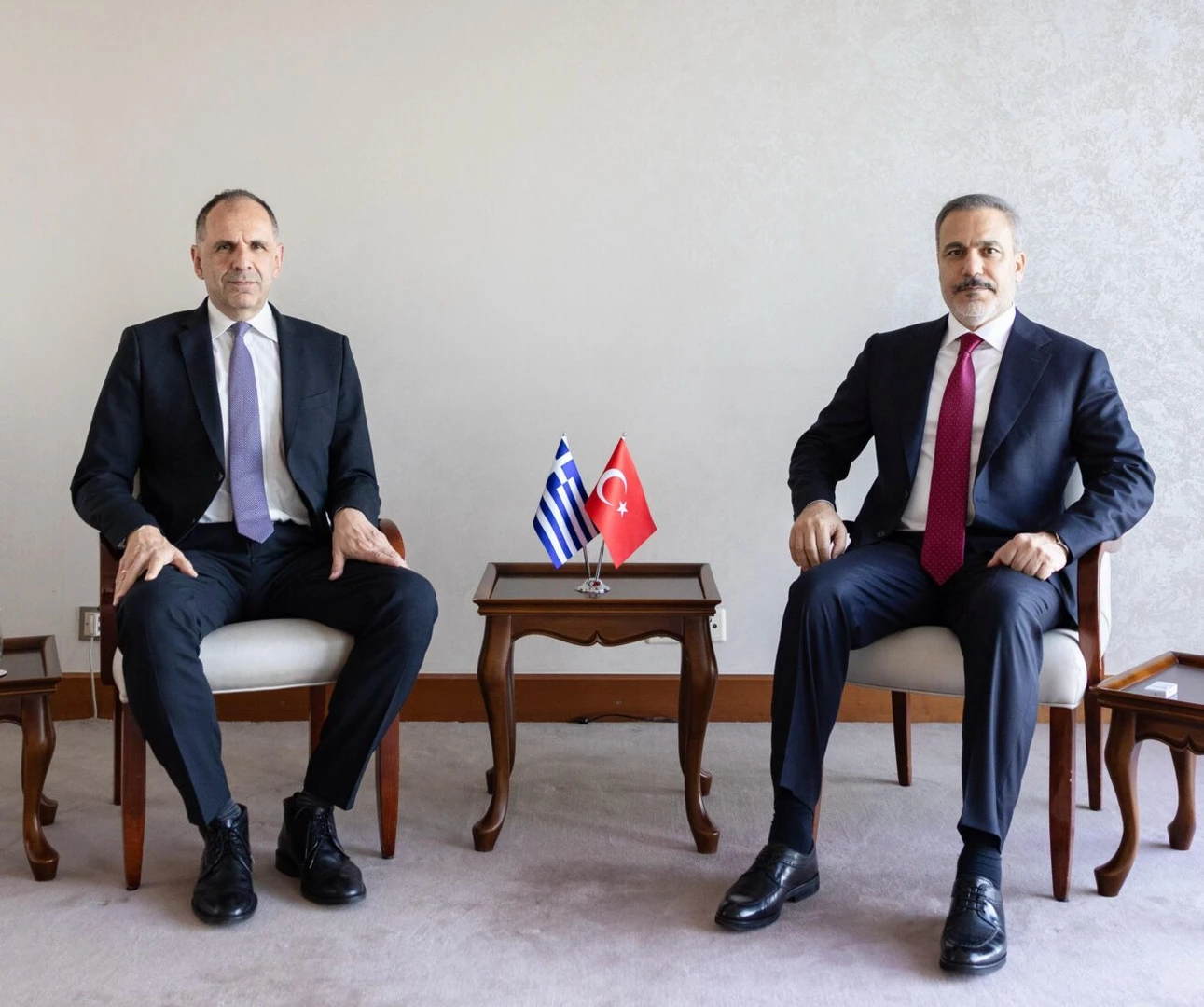 Photo shows turkey Foreign Minister Hakan Fidan (R) sitting next to Greek Foreign Minister Giorgos Gerapetritis (L)