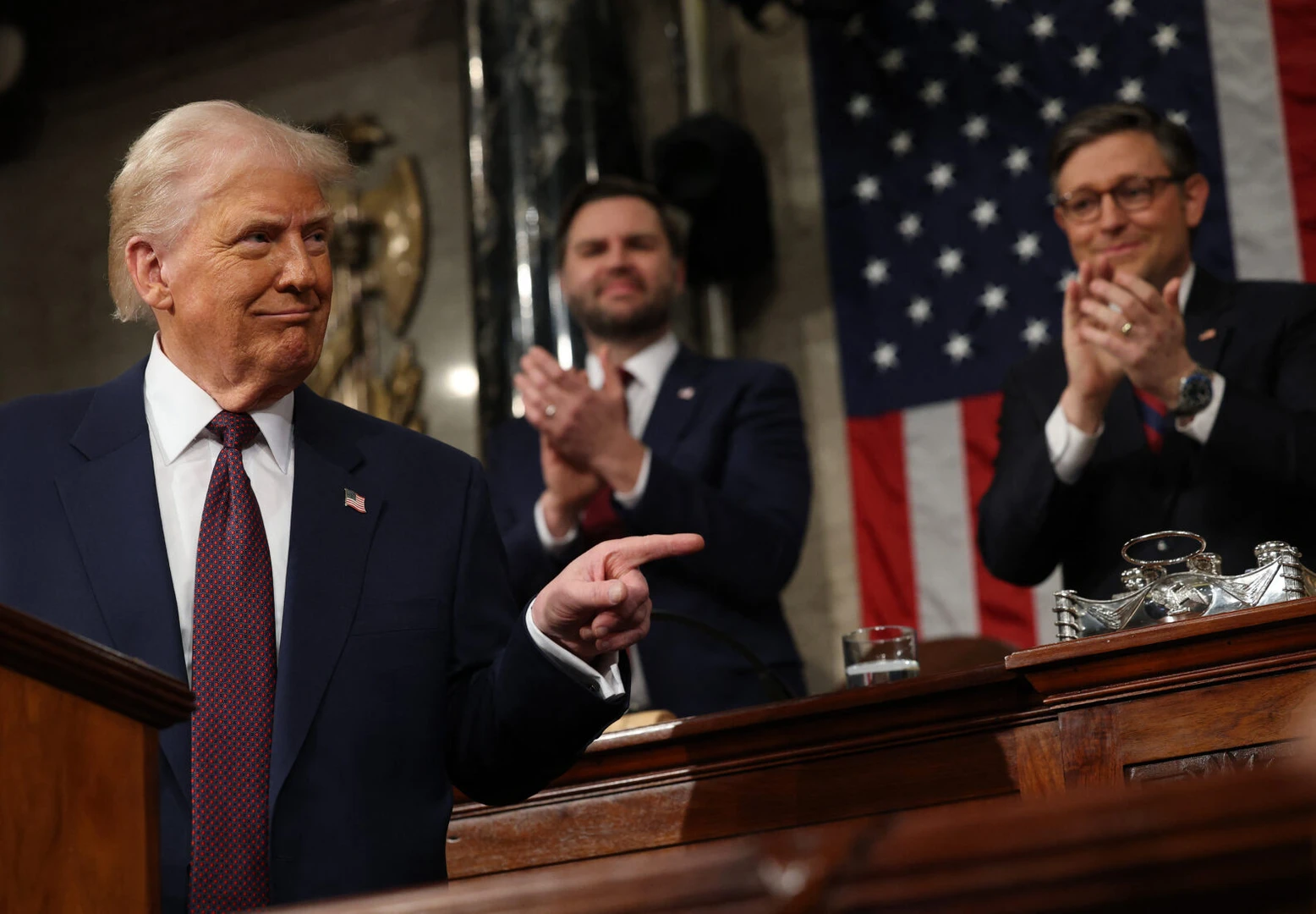 The image shows Donald Trump in a dark suit