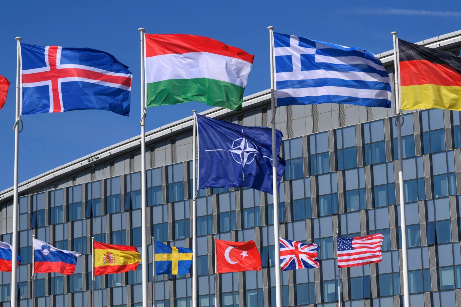 Photo shows the member nation flags in the Cour d'Honneur of NATO headquarters.