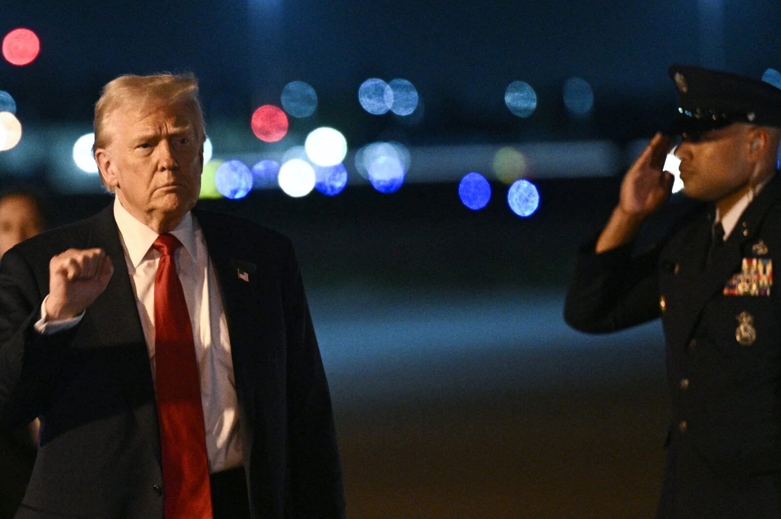 US President Donald Trump gestures as he arrives at Palm Beach