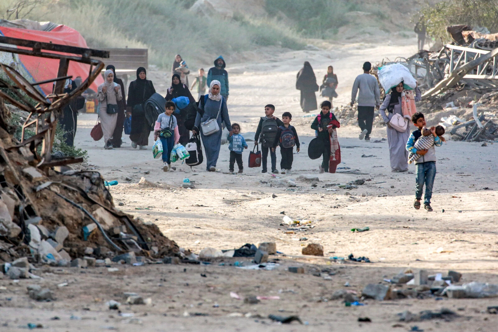 Photo shows displaced people walking to escape conflict in Gaza.