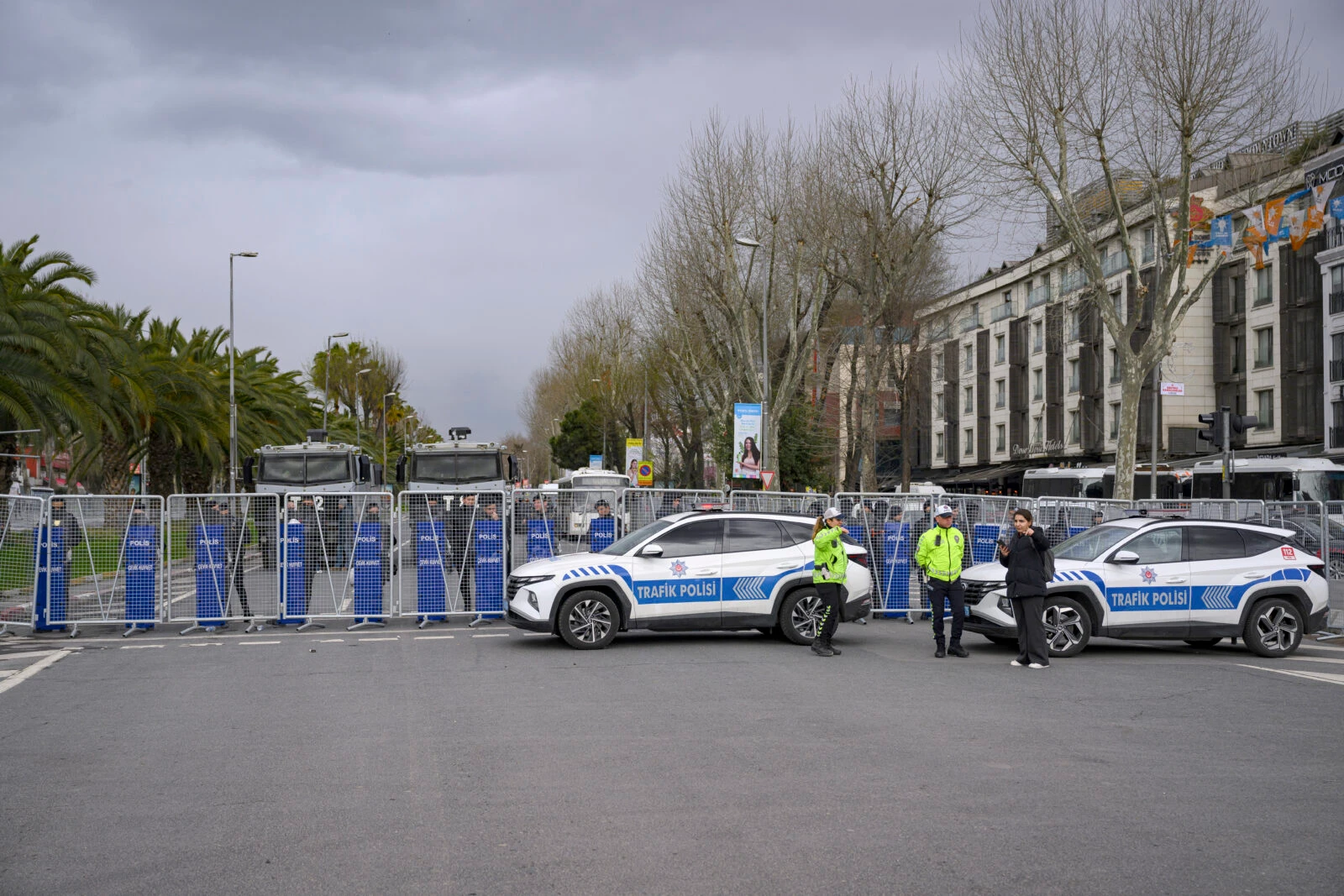 Photo shows Turkish police officers holding barricade.