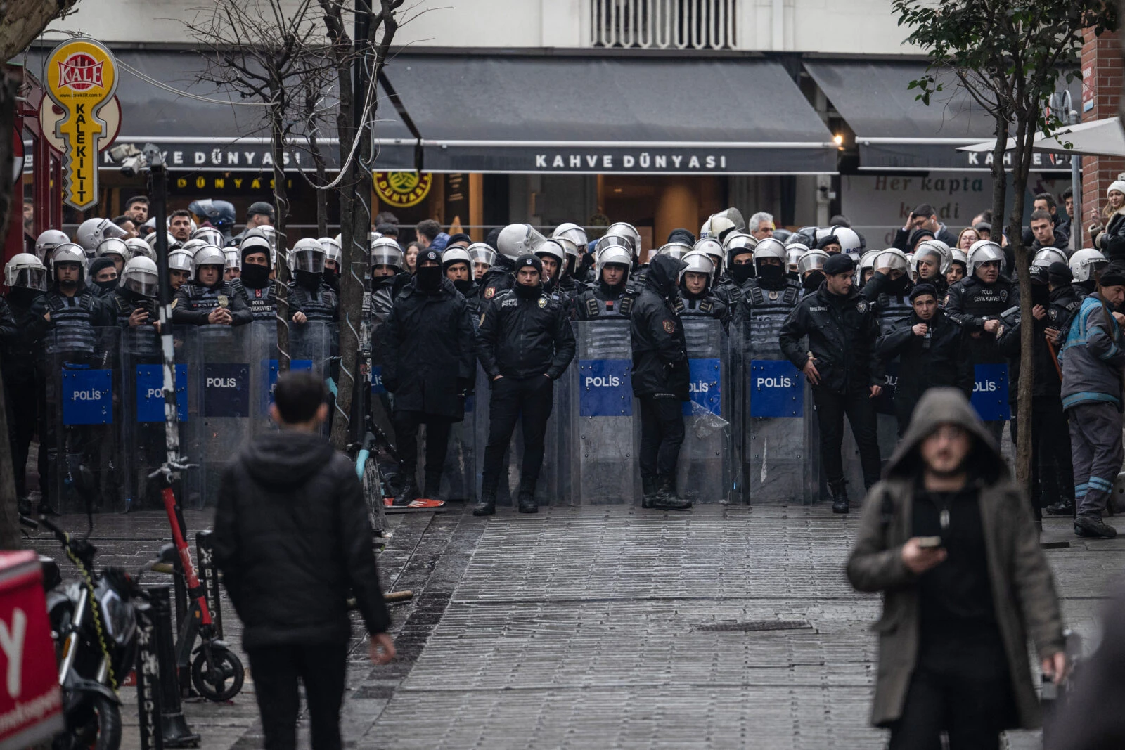 Photo shows Turkish anti-riot police officers blocking a street as University students march.