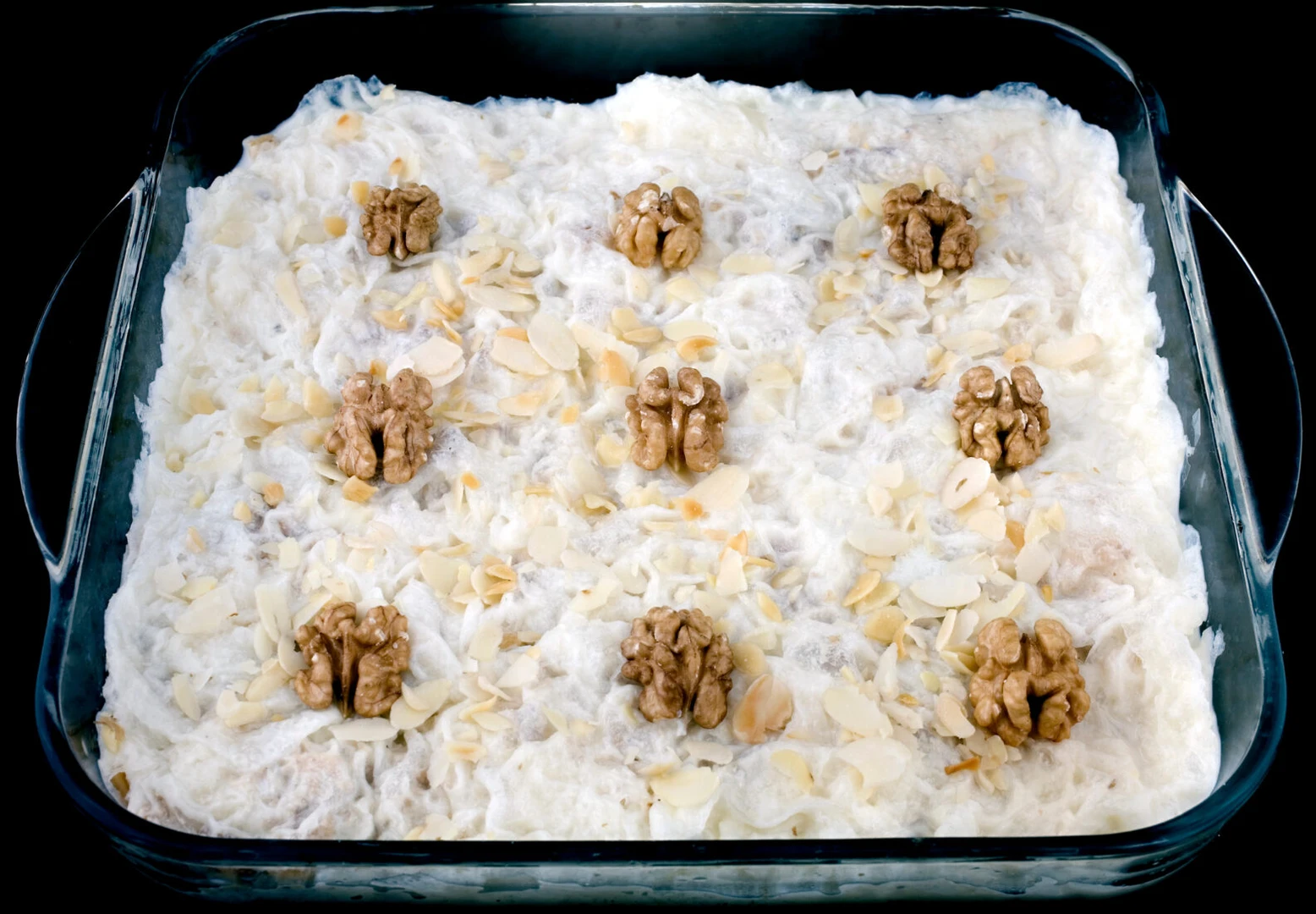 Traditional Turkish gullac dessert in a black container.