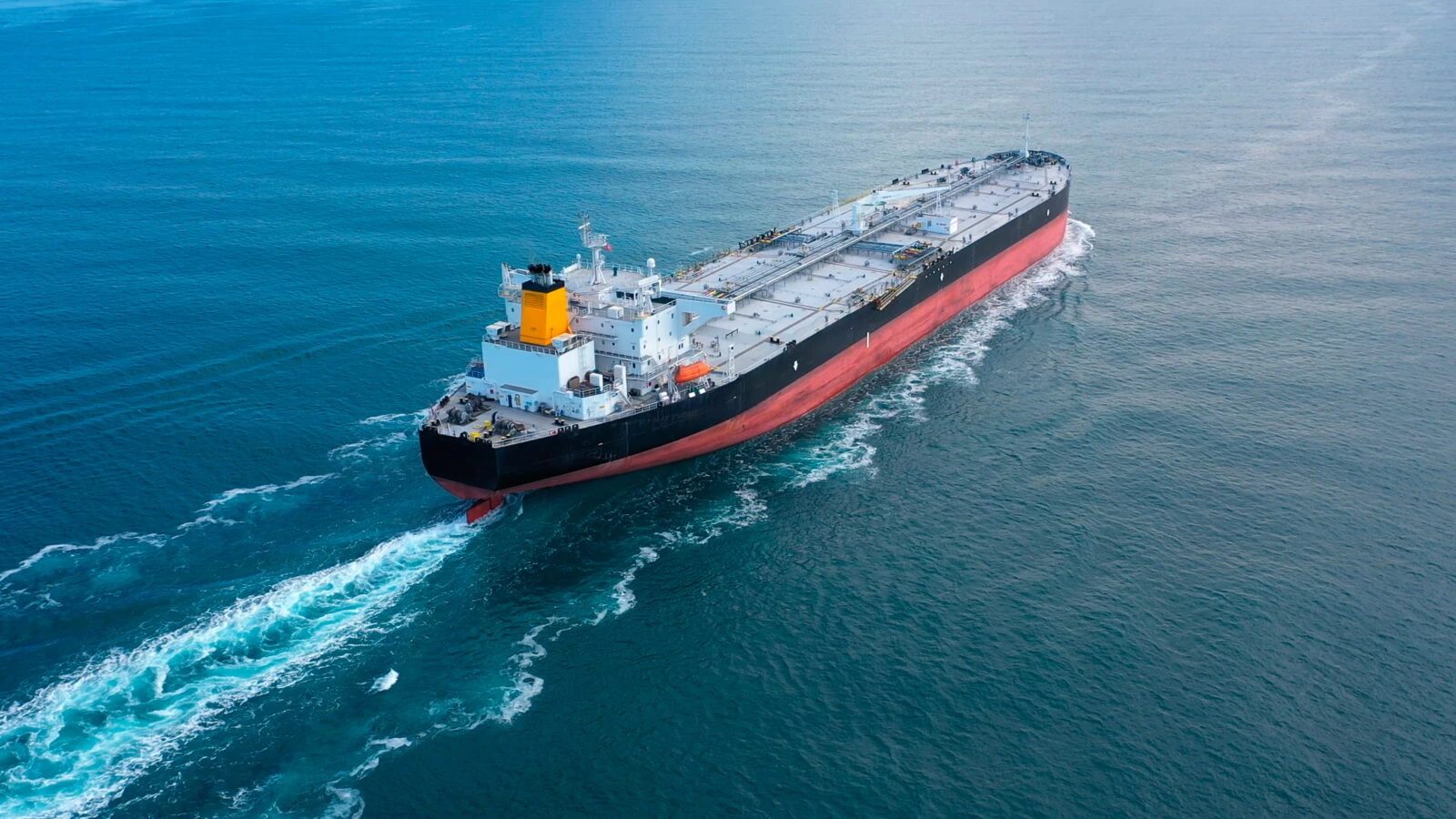 Oil tanker underway towards open sea. Crude oil tanker ship, a merchant ship specially designed for chemical products transportation. Aerial view. Black Sea