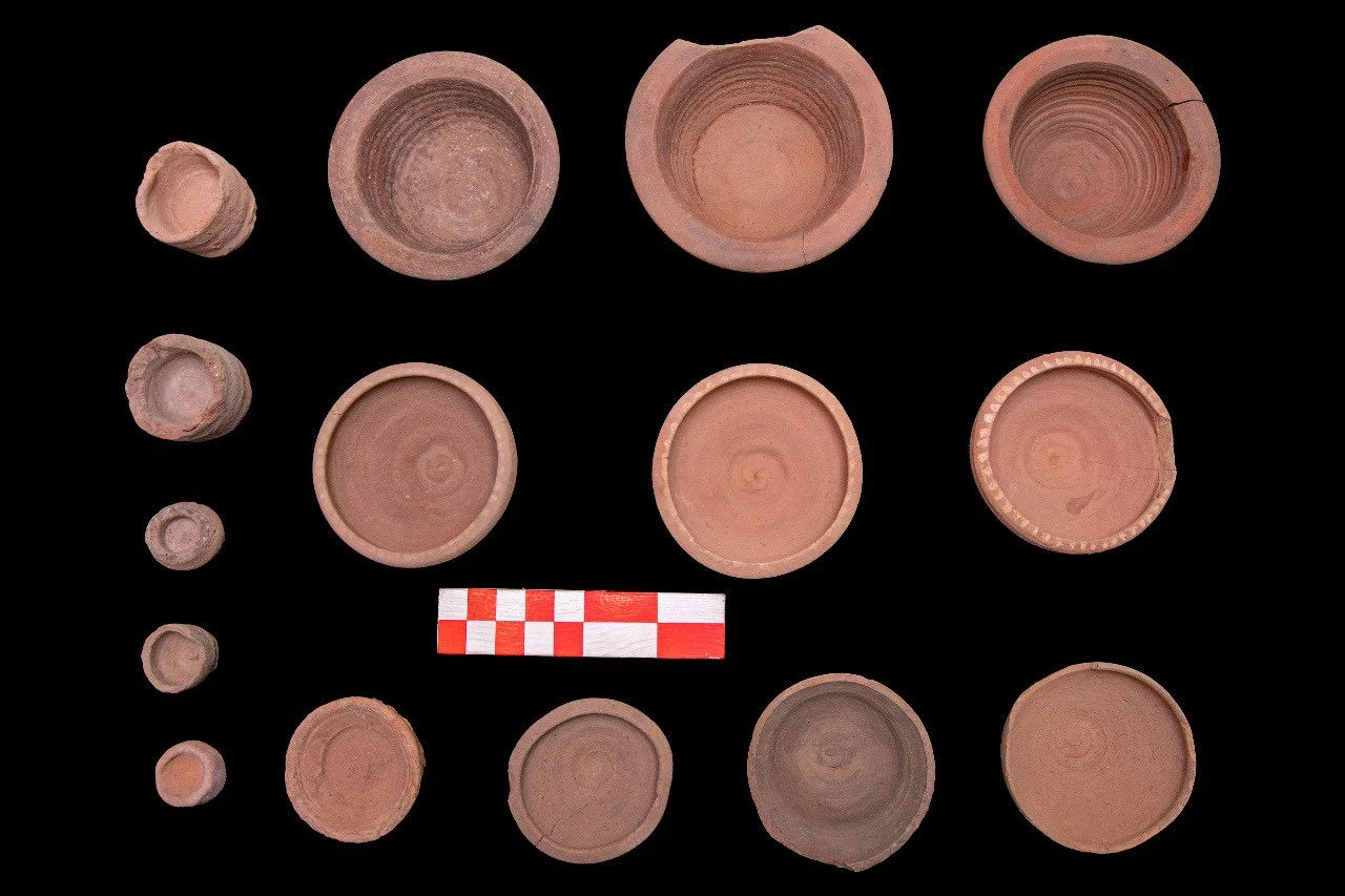 A Roman-era pottery workshop unearthed in Banawit, Egypt, showcasing ancient kilns and pottery fragments.