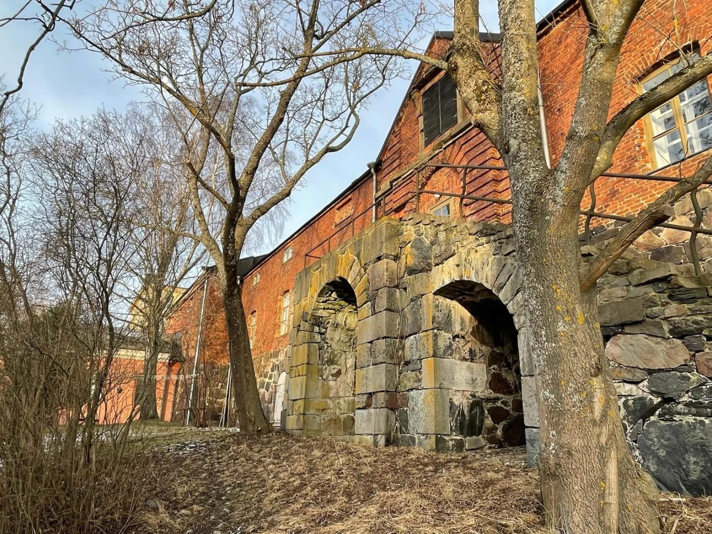 Colorful traditional houses on Suomenlinna Island, Finland, with a peaceful winter atmosphere.