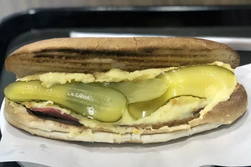 A close-up of a Görali sandwich, a Turkish street food classic.