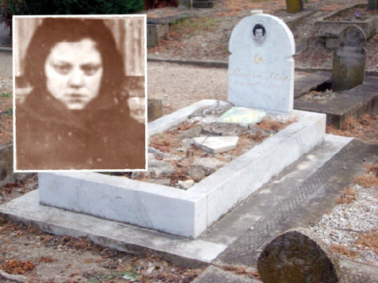 A white tombstone with a crescent moon symbol, marking the grave of Selma Sultana in Paris, with an inset historical photo of her.