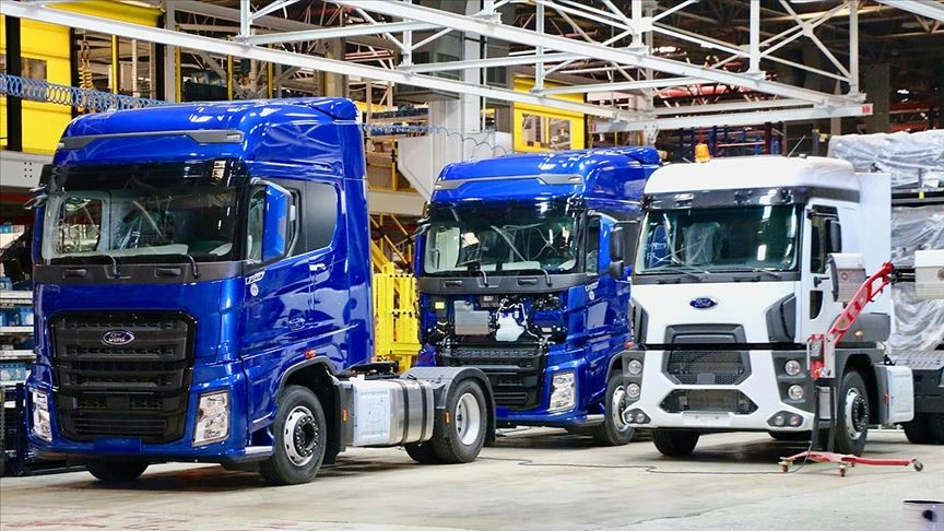 A row of Ford heavy-duty trucks in various stages of assembly