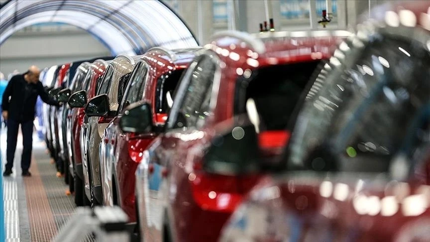 Worker inspects newly assembled cars in Turkish auto plant