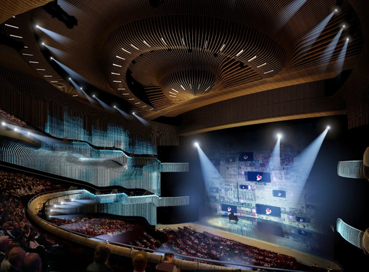 Interior view of Zorlu Performing Arts Center showing a multi-tiered auditorium with curved wooden slat ceiling design