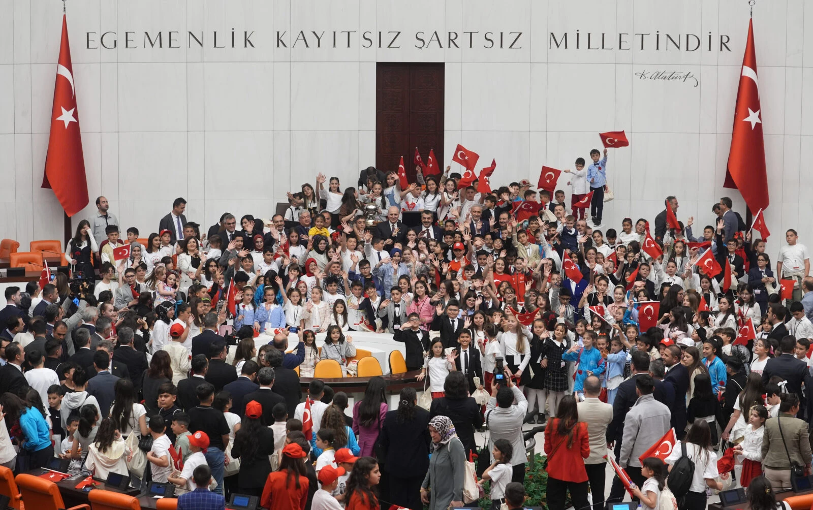 Public transportation to be free in Istanbul, Izmir, Ankara on April 23 3 A general view of the assembly of the Turkish Parliament as children are seen holding Turkey's flag.