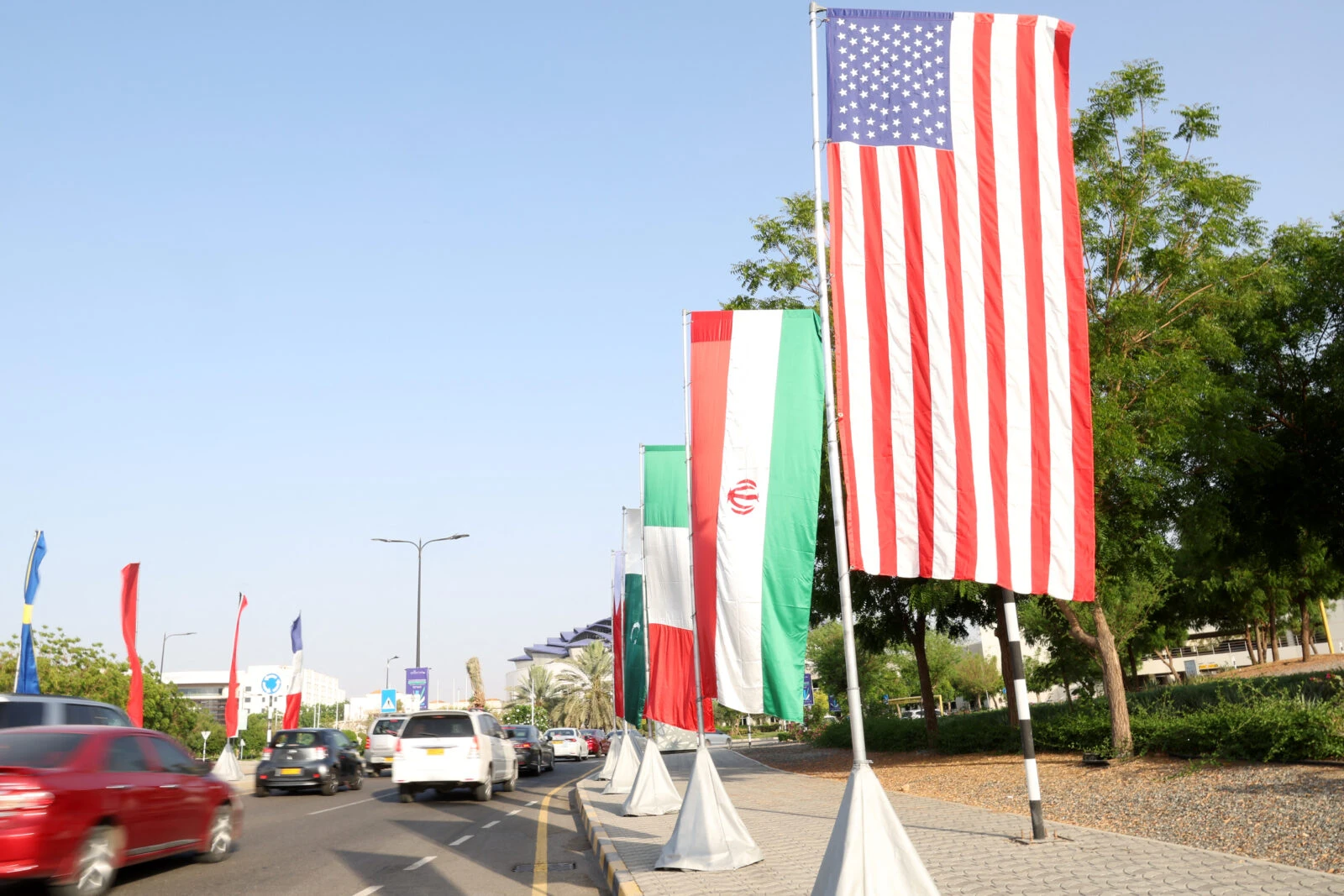 Trump urges immediate halt to Iranian oil purchases, warns of sanctions 4 Photo shows flags of the US and Iran hang on the road.