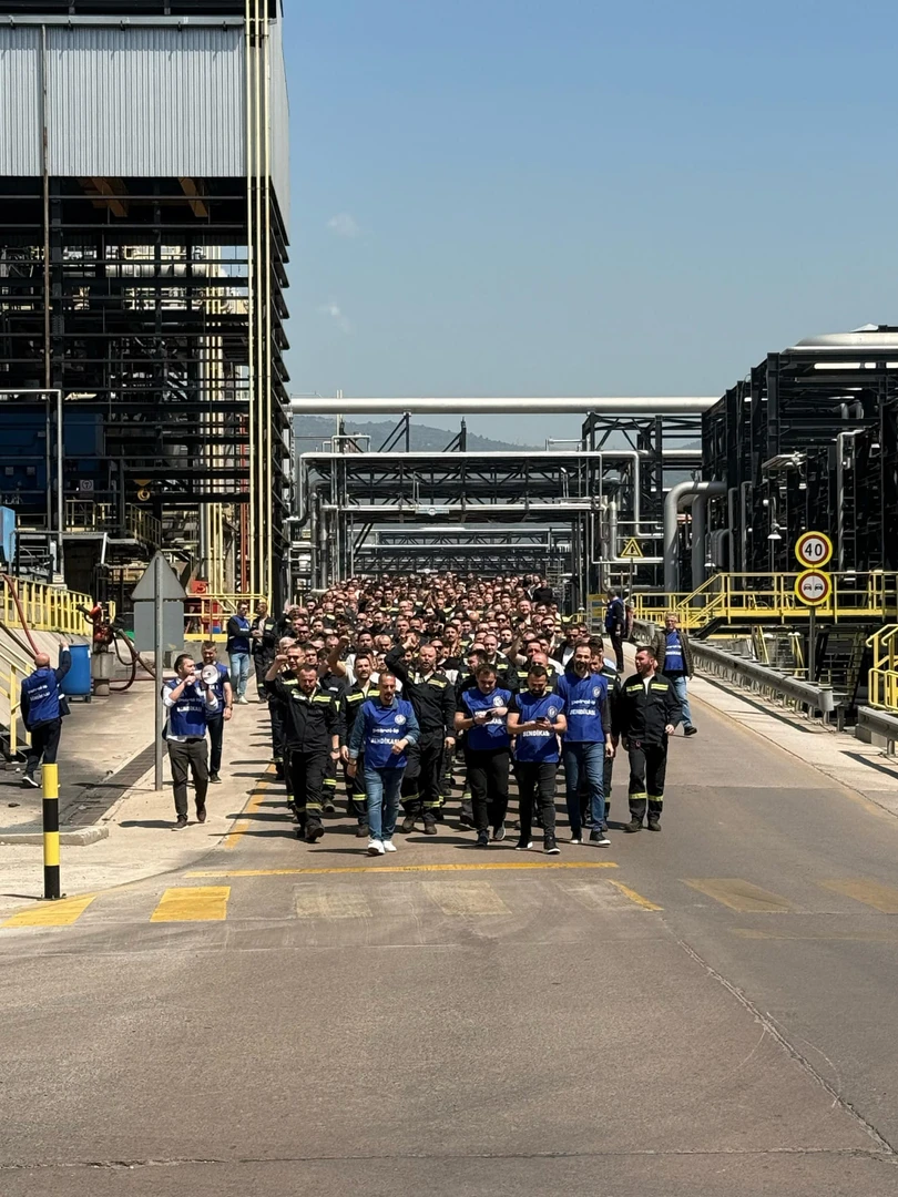 Refinery workers in uniform march together